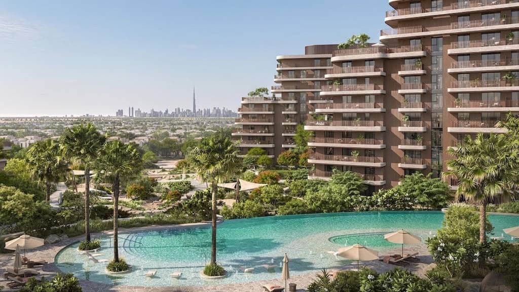 The Wilds by Aldar — terraced residences over landscaped gardens with the Dubai skyline beyond
